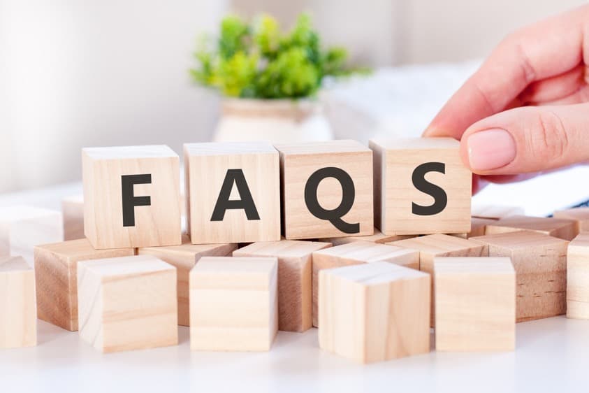 businesswoman-hand-holding-faq-word-with-wooden-cube-block